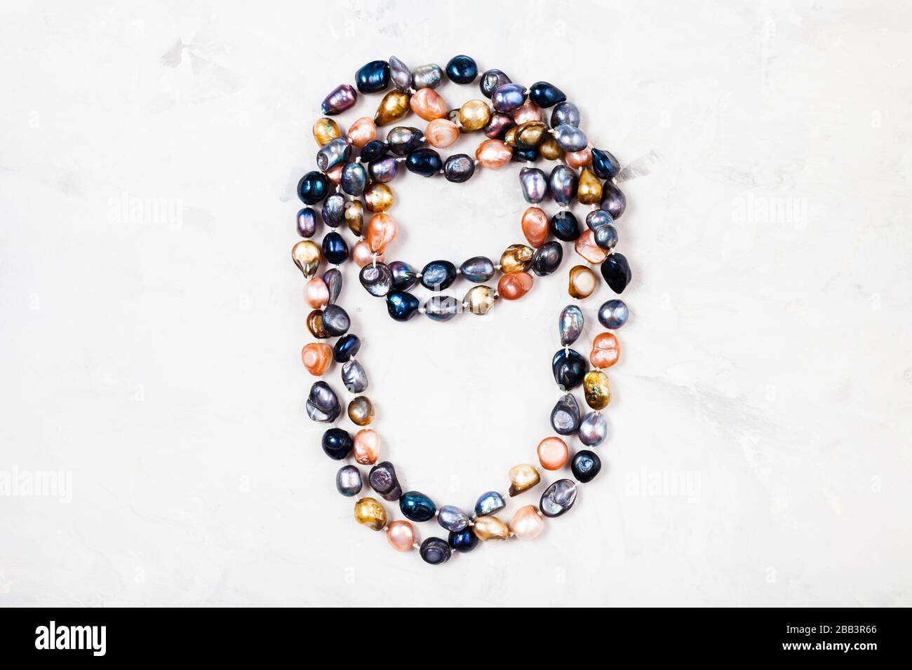handmade necklace from various river pearls on gray concrete background Stock Photo