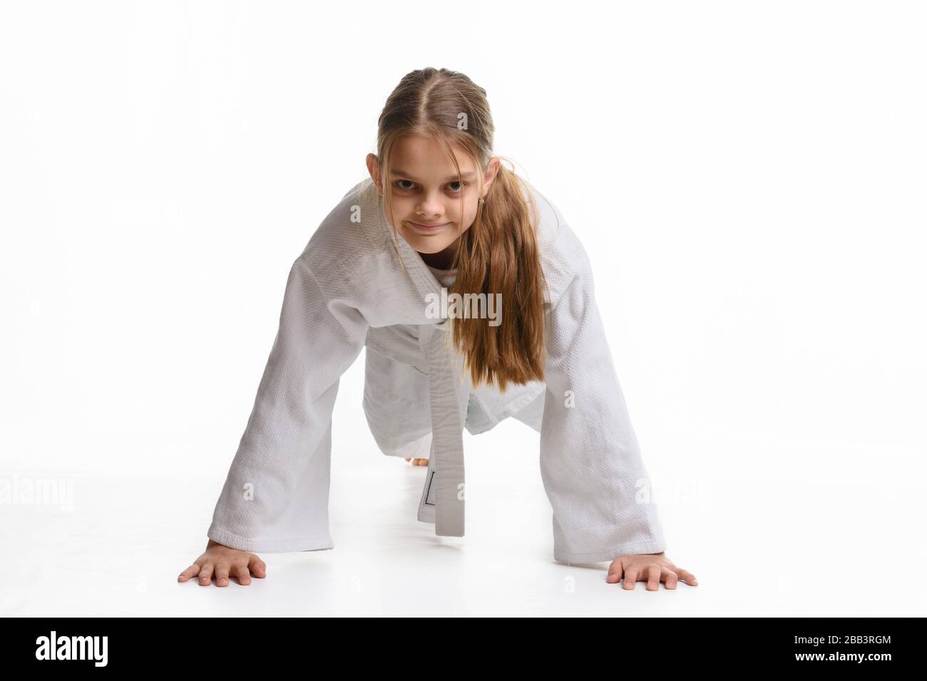 Girl pushUPS from the floor in a sports keikogi Stock Photo Alamy