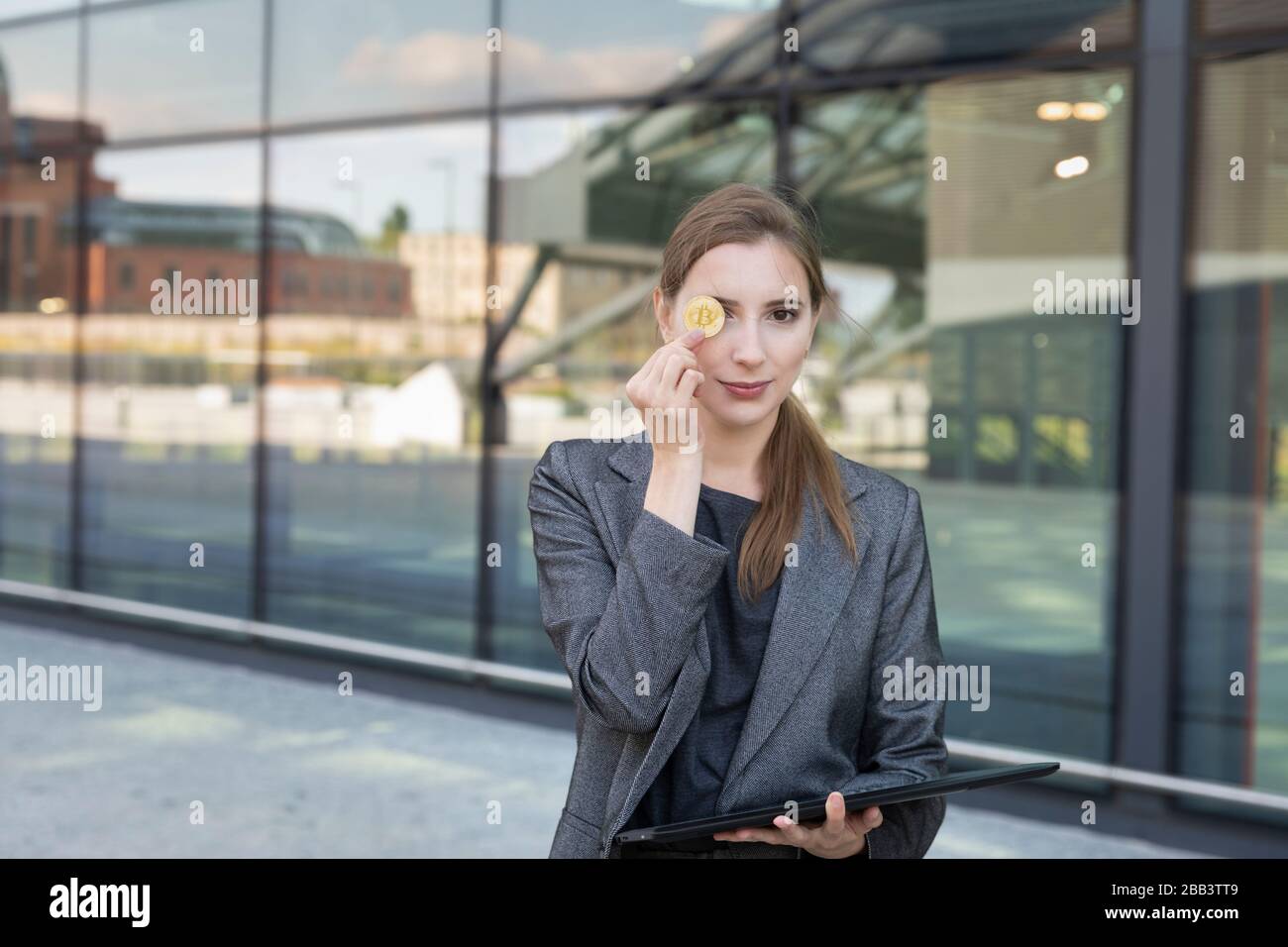 The young beautiful woman holds bitcoin in a hand. She is a business lady  and invested her money in cryptocurrency, planning to make good money on it  Stock Photo - Alamy