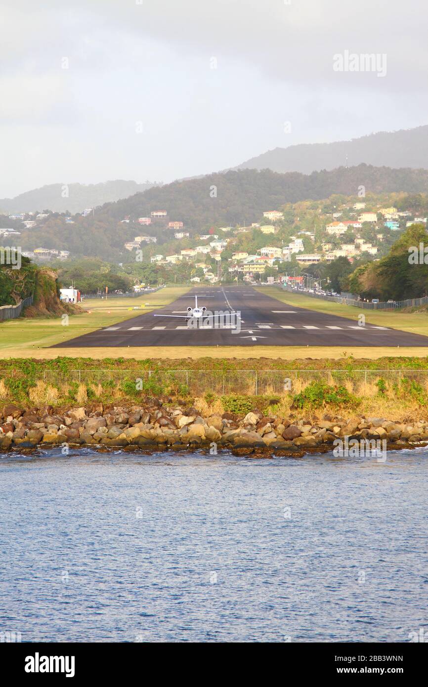 AIRSTRIP OF GEORGE F. L. CHARLES AIRPORT ON THE CARIBBEAN ISLAND OF SAINT LUCIA. THE OLD NAME FOR THE AIRPORT WAS VIGIE AIRPORT. END OF THE STRIP AT THE WATERS EDGE. Stock Photo