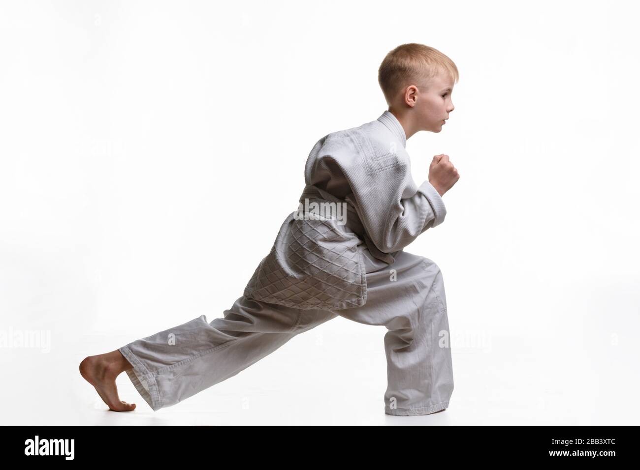 Martial arts student crouches and stretches his legs Stock Photo Alamy