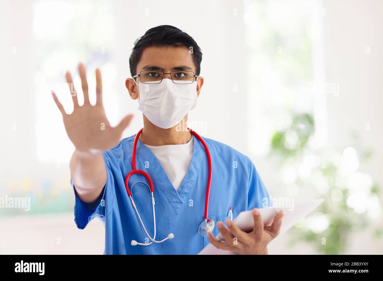 Asian doctor or nurse with stethoscope and face mask. Medical