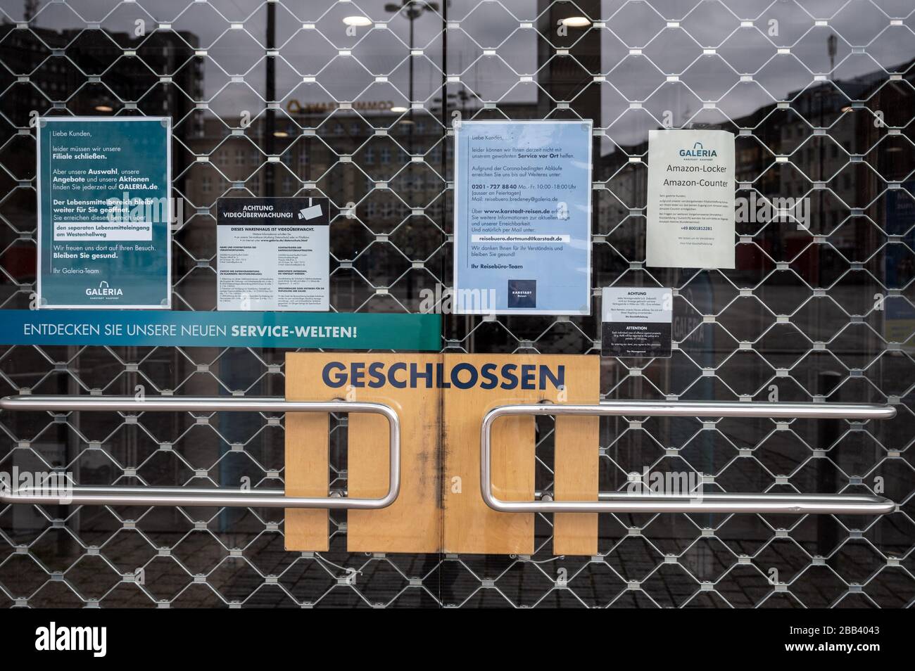 Dortmund, Germany. 30th Mar, 2020. The doors to a Karstadt store are closed with a rolling grille. The department store group Galeria Karstadt Kaufhof is still waiting for government aid. The business in the department stores is largely, but not completely, at rest. Around 50 food departments of the company are still open. Credit: Bernd Thissen/dpa/Alamy Live News Stock Photo