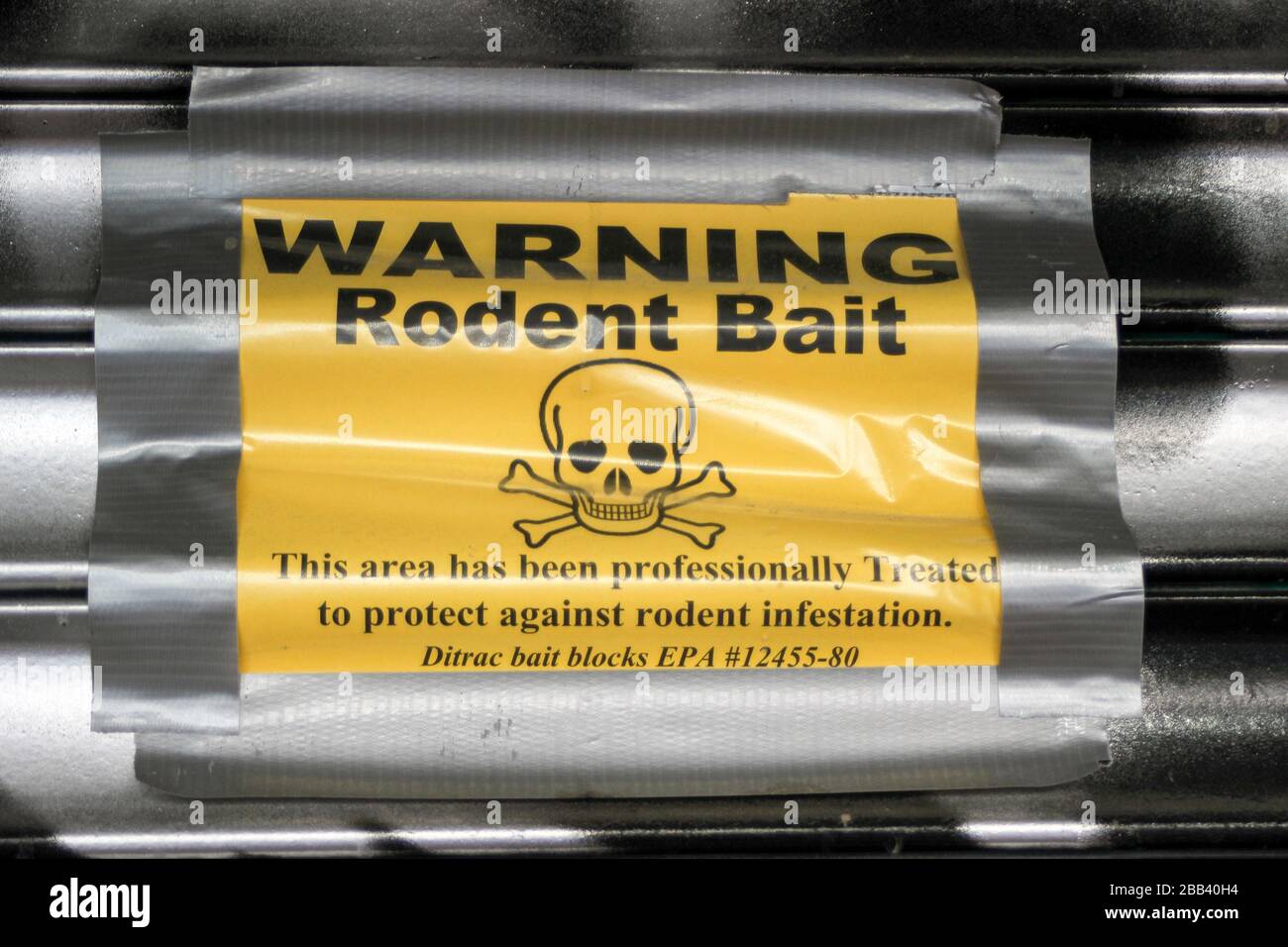 Rodent bait warning poster on a roll-up door in Lower East Side, Manhattan, New York City, United States of America Stock Photo