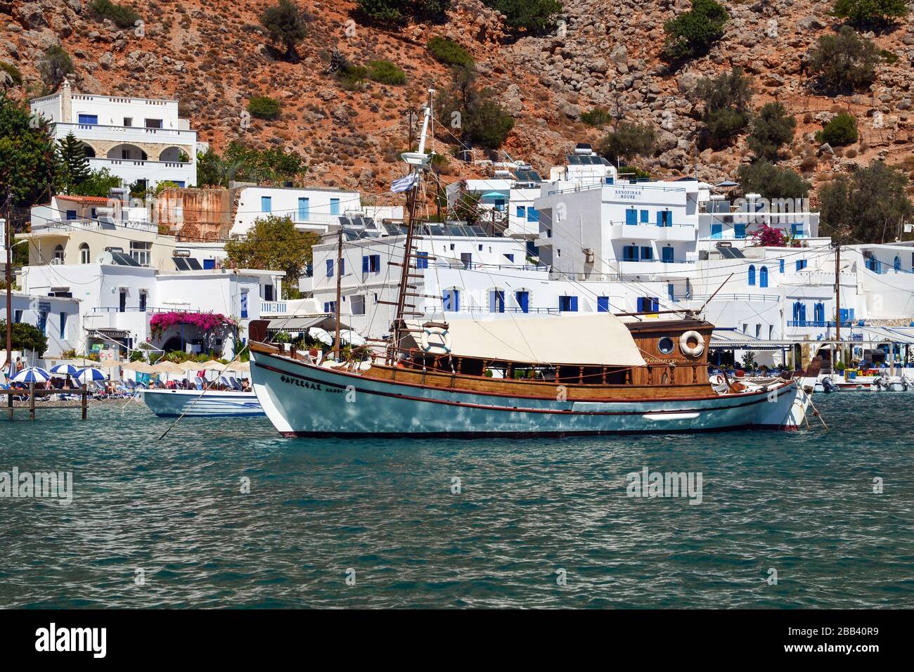LOUTRO, CRETE (GREECE) - SEPTEMBER 19, 2013: Beautiful sailboat docked in Loutro, island of Crete, Greece. Stock Photo