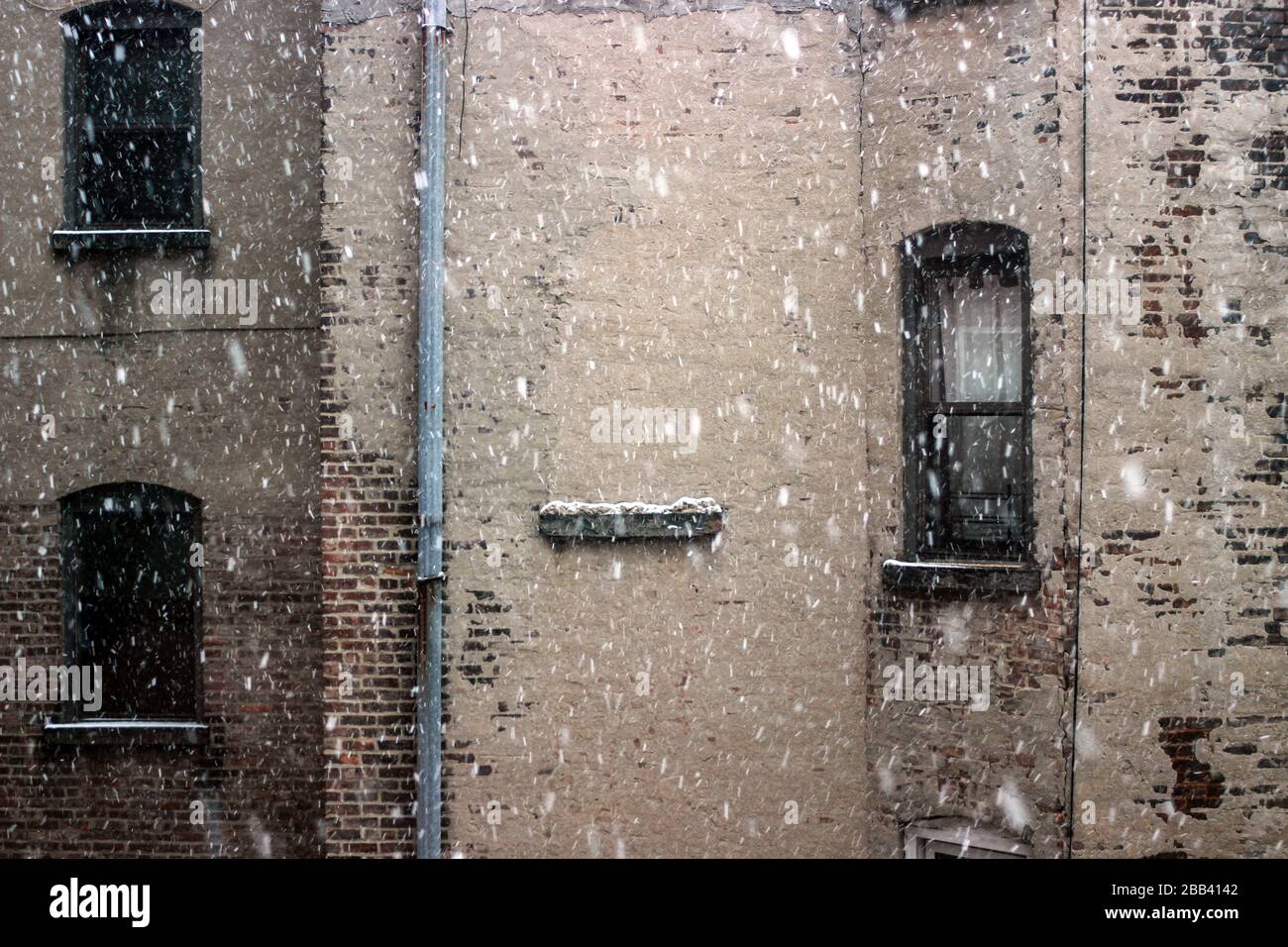 Snow falling in to Lower East Side apartment block inner yard in Manhattan, New York City, United States of America Stock Photo
