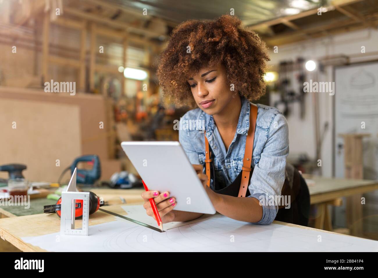 Afro american woman craftswoman working in her workshop Stock Photo