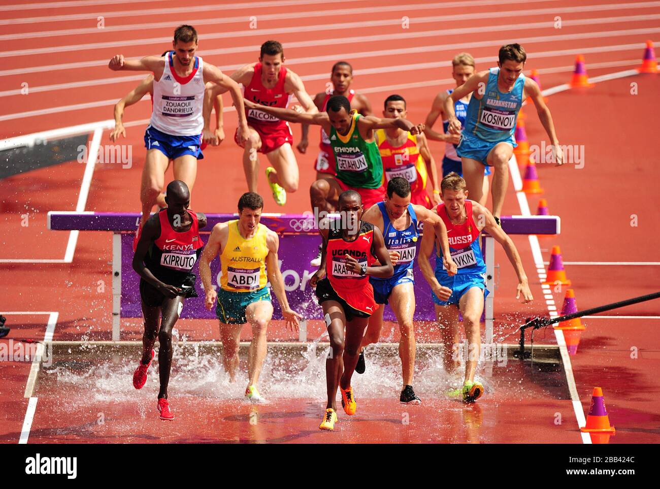 Competitors go over the water jump during heat 2 of Round 1 of the Men