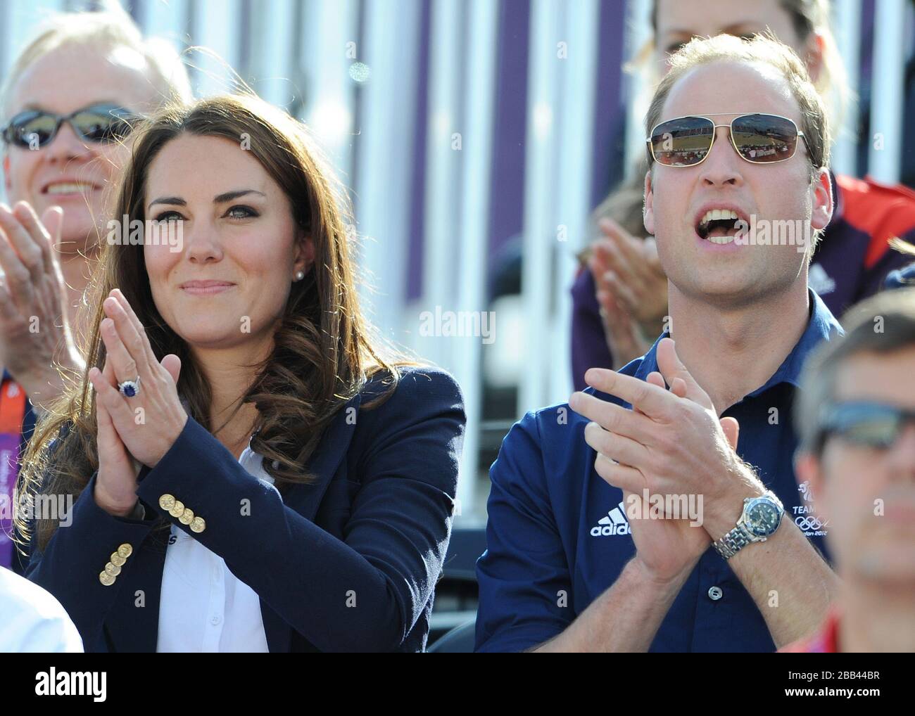 The Duke and Duchess of Cambridge cheer Zara Phillips as she enters the Arena during the Cross Country Phase of The Eventing at Greenwich Park, on the third day of the London 2012 Olympics. Stock Photo