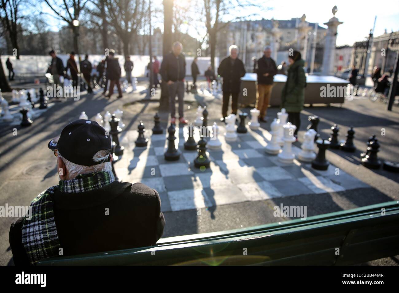 Men Playing Chess On A Giant Chess Board In The Parc Des Bastions, Geneva, Switzerland Stock Photo