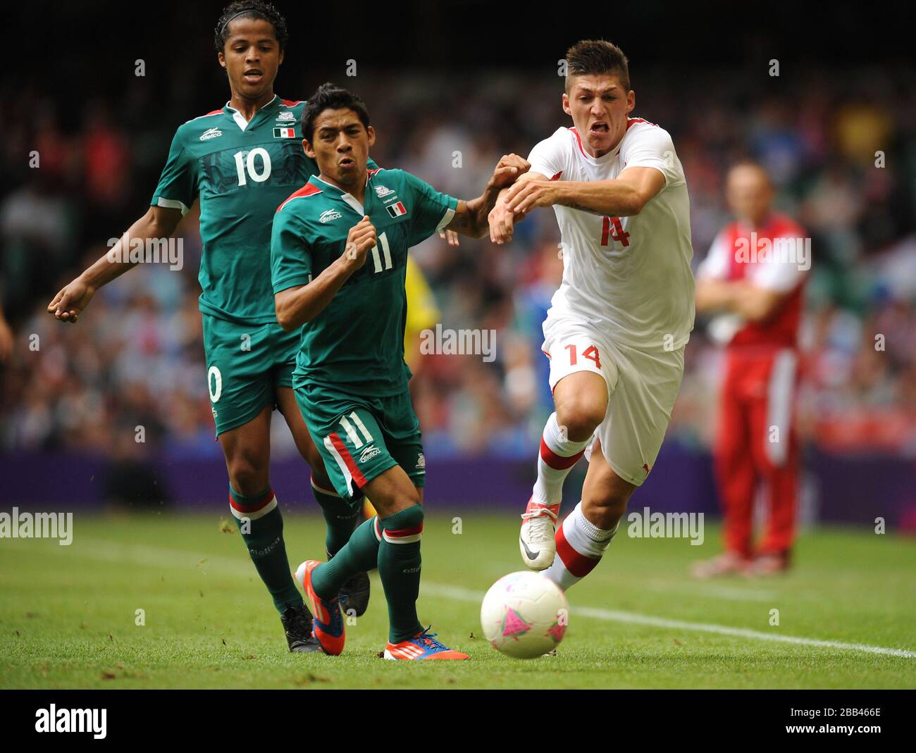 Switzerland's Steven Zuber (right) and Mexico's Javier Aquino battle for the ball during the group B match at the Millennium Stadium Stock Photo