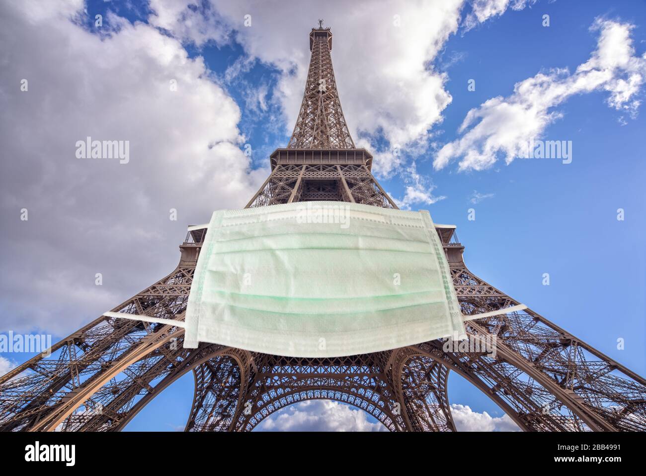 Eiffel tower wearing a surgical mask. New coronavirus, covid-19 in Paris France epidemic crisis concept Stock Photo