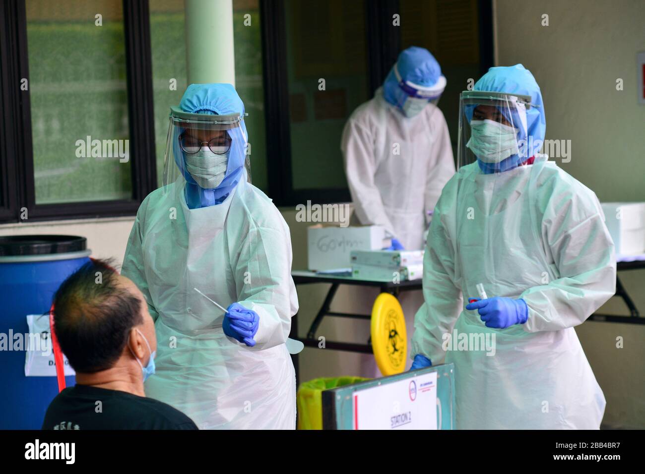 Kuala Lumpur, Malaysia. 30th Mar, 2020. A medical staff member takes the sample from a man at a COVID-19 testing area of a hospital in Damansara near Kuala Lumpur, Malaysia, March 30, 2020. A total of 37 people have died of the COVID-19 in Malaysia as of Monday with 156 newly confirmed cases, bringing the total to 2,626, said the Health Ministry. Credit: Chong Voon Chung/Xinhua/Alamy Live News Stock Photo