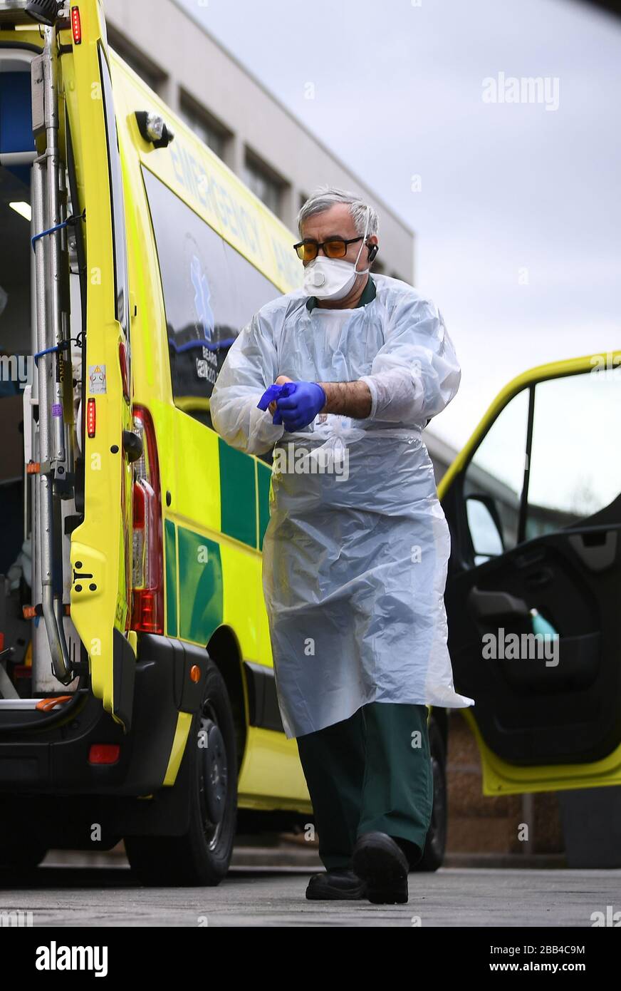 A paramedic wearing personal protective equipment ppe exits hires