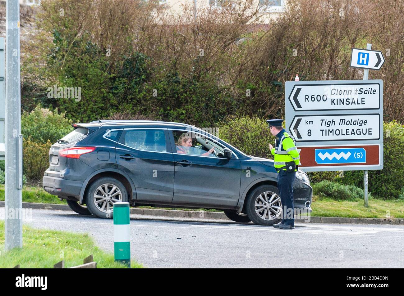 Clonakilty, West Cork, Ireland. 30th Mar, 2020. As part of the mandatory 'Stay at Home' order imposed by the Irish government on Friday last, the Gardai have been tasked to ensure people are complying to help stop the spread of Covid-19. A Garda Checkpoint was in place on the Clonakilty to Bandon road this afternoon which consisted of 3 regular Gardai and 2 Armed Gardai. Credit: AG News/Alamy Live News Stock Photo