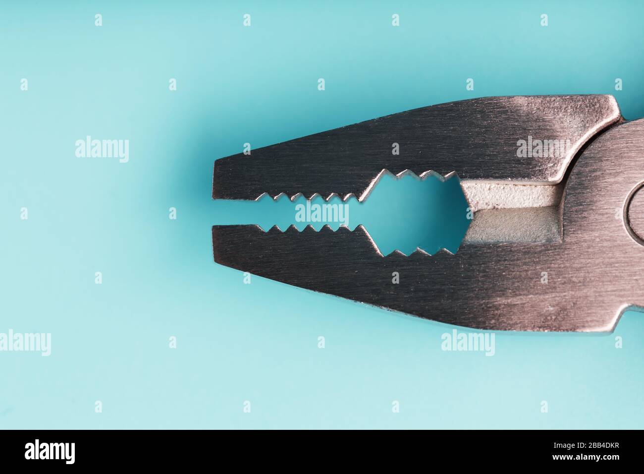 The multitool multi-function tool hovers on a blue background. The concept of an expanded multi-tool with free space. Stock Photo