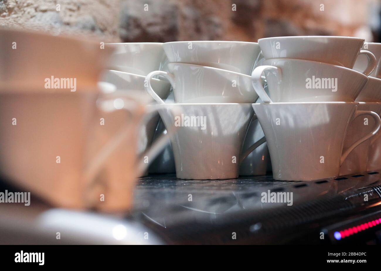 Coffee cups on top of an espresso machine at The Station Cafe Bar in Richmond, North Yorkshire, UK. 21/9/2018. Photograph: Stuart Boulton. Stock Photo