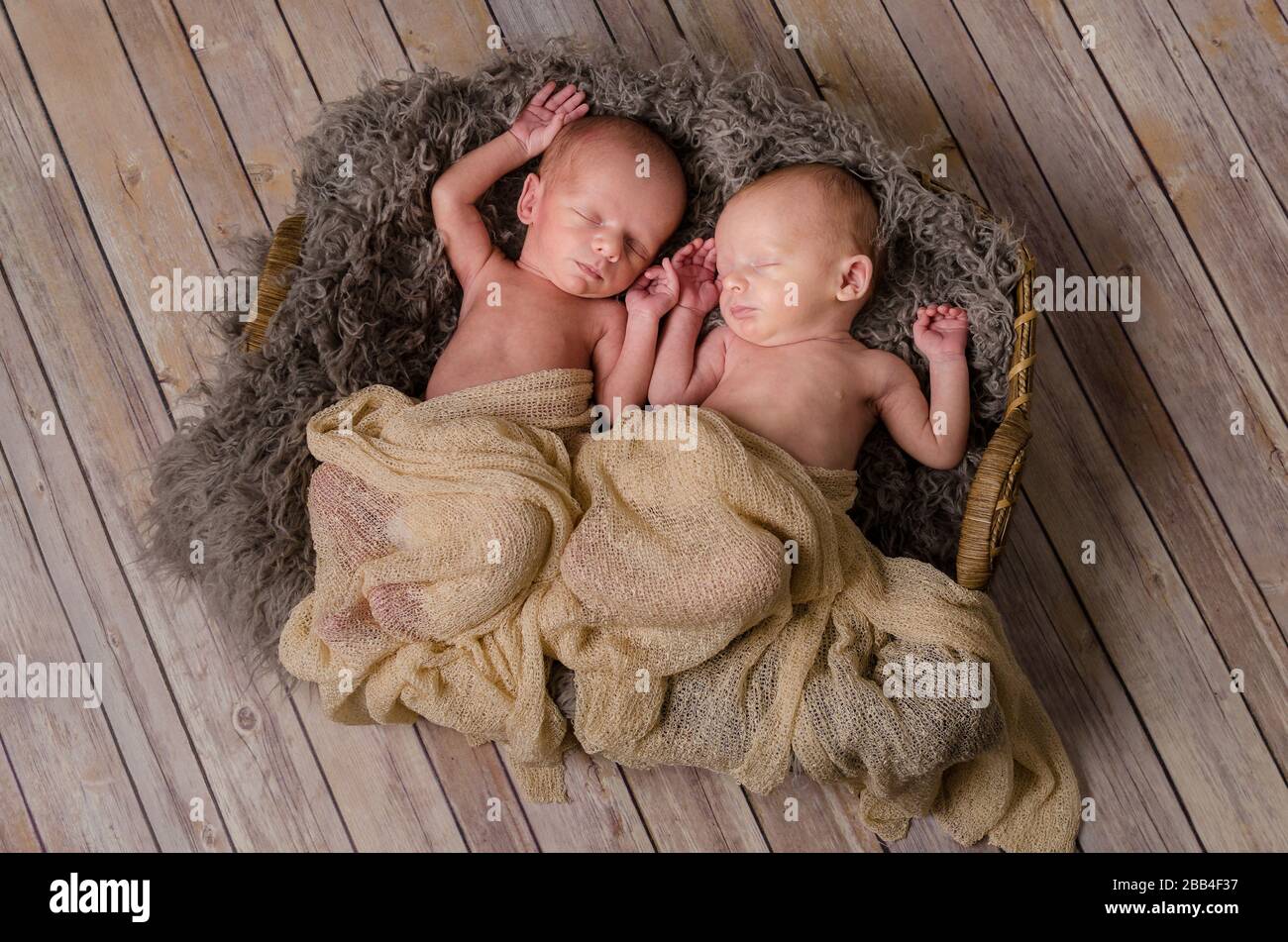 Soft earthtone blankets over a rustic wooden floor Stock Photo