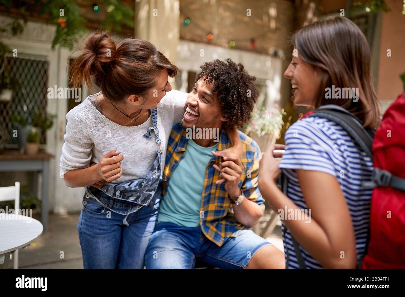 Happy guy with girls rejoices together in cafe Stock Photo