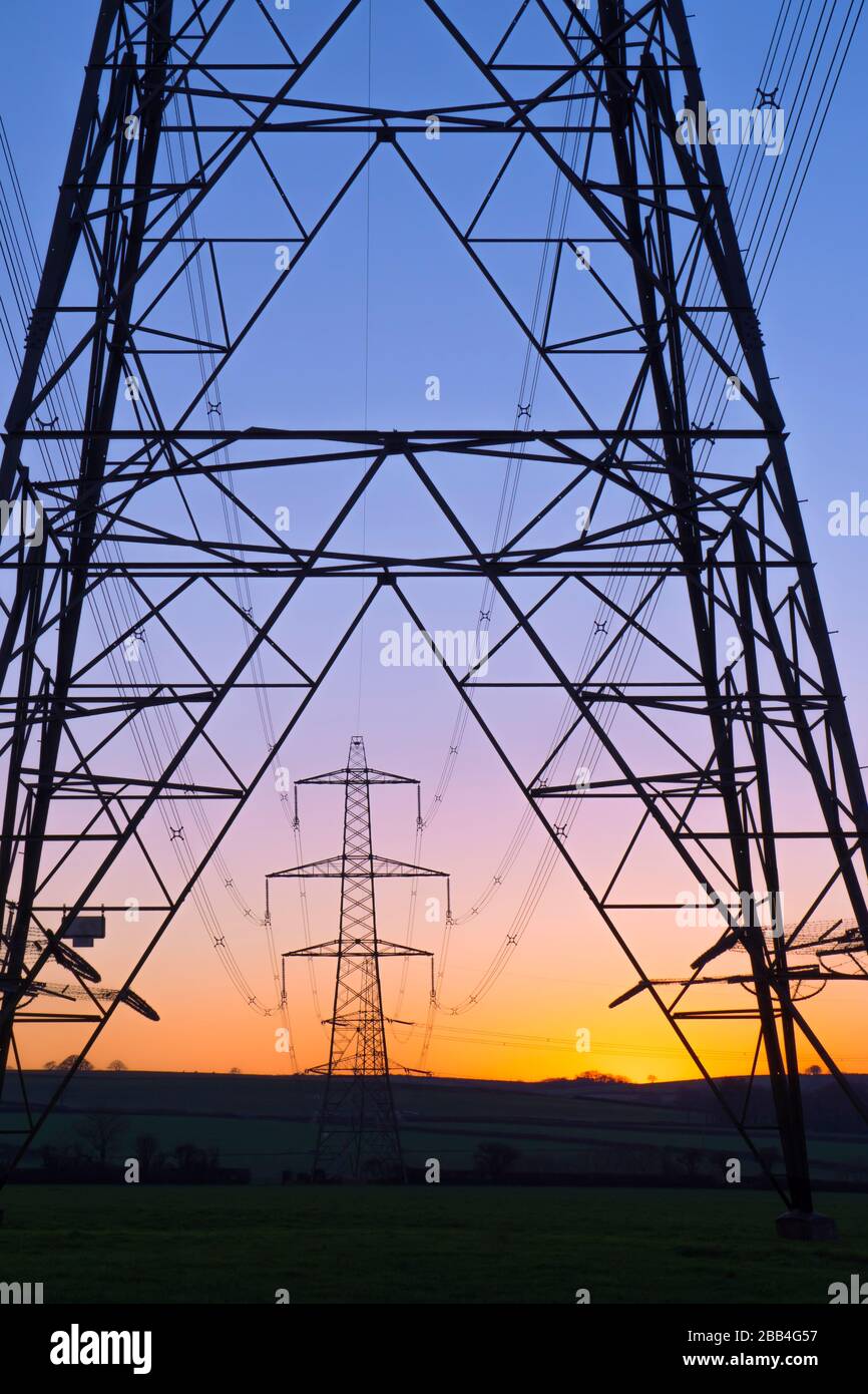 An electricity pylon of the National Grid in Wales at sunset Stock Photo