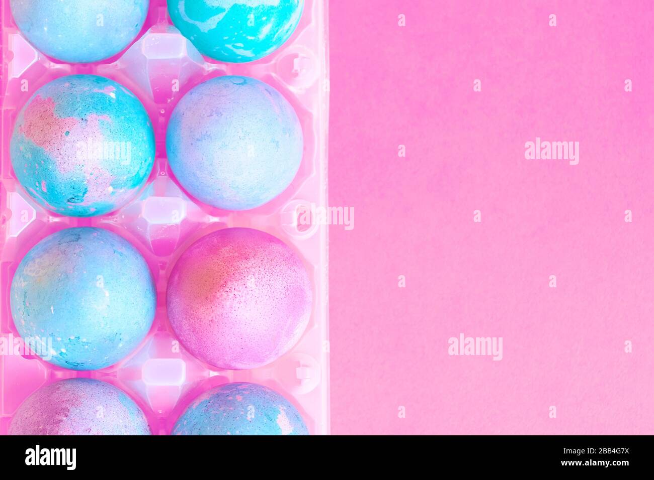 Painted Easter eggs with space intergalactic pattern in stand on magenta background Stock Photo