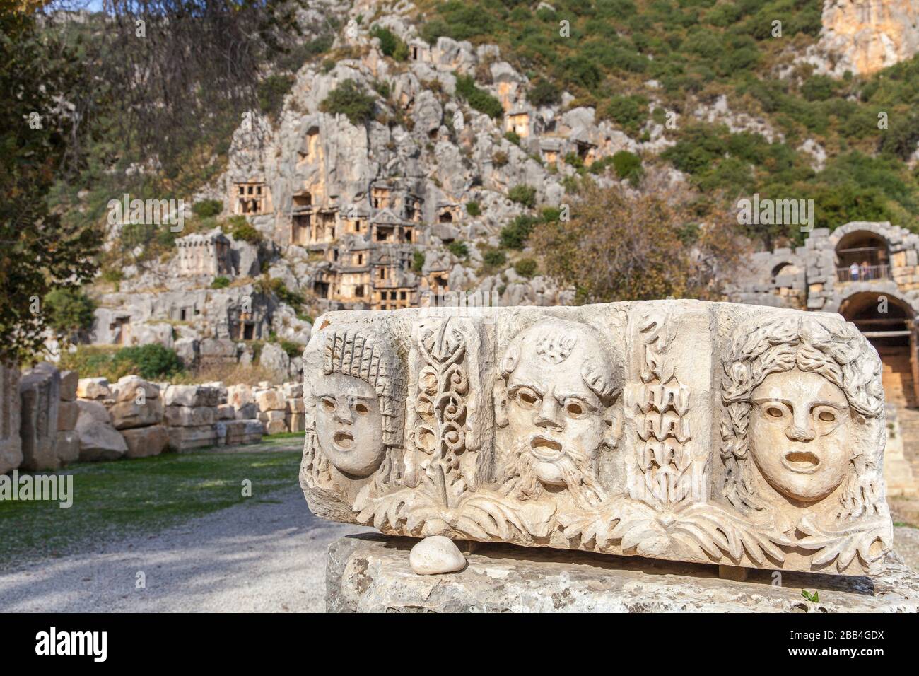 old stone masks used in theater actors in the rock tombs in Myra ancient city of Antalya in Turkey. Stock Photo