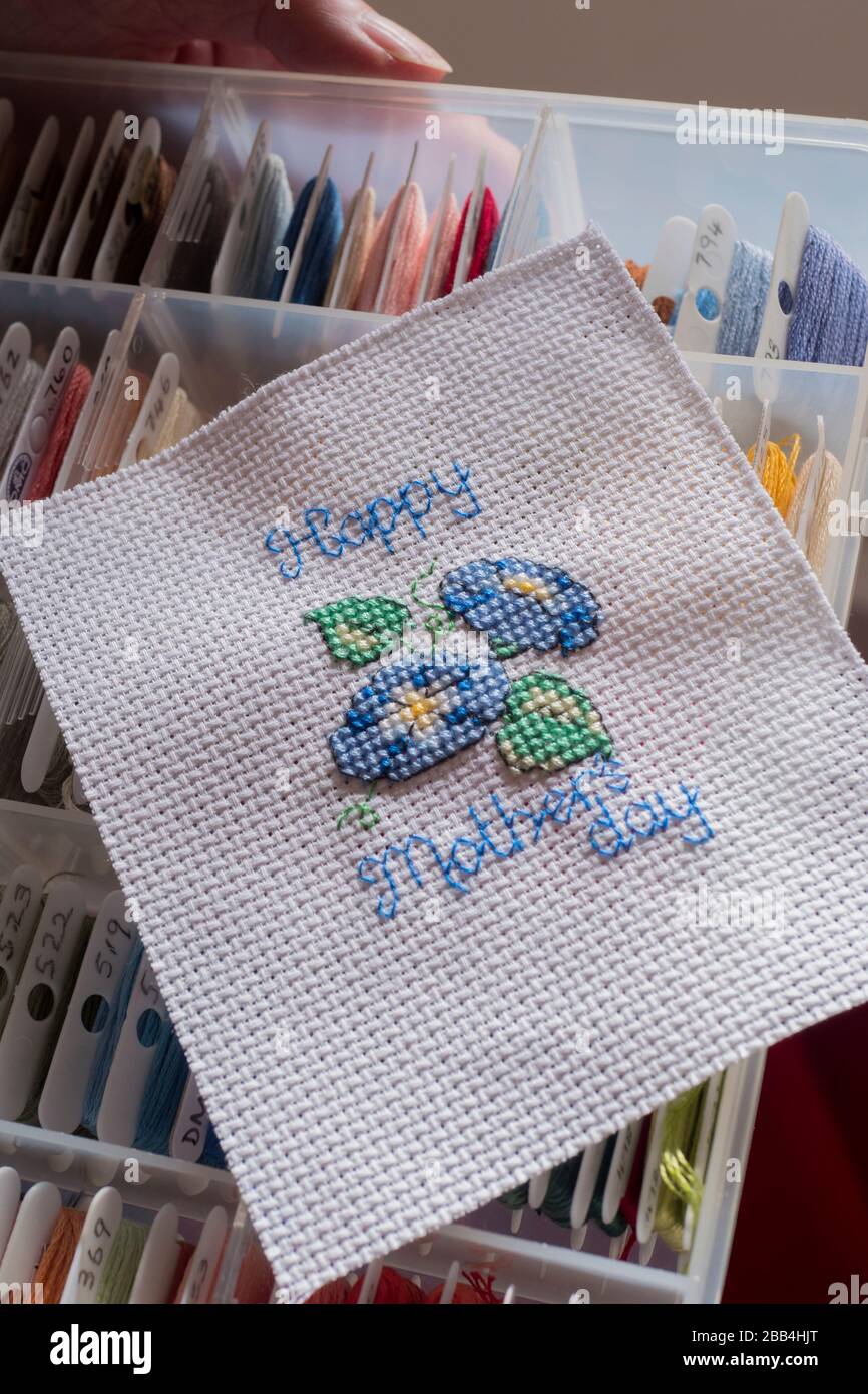 Embroidery Threads for cross stitch in a storage box with completed cross stitch Stock Photo Alamy