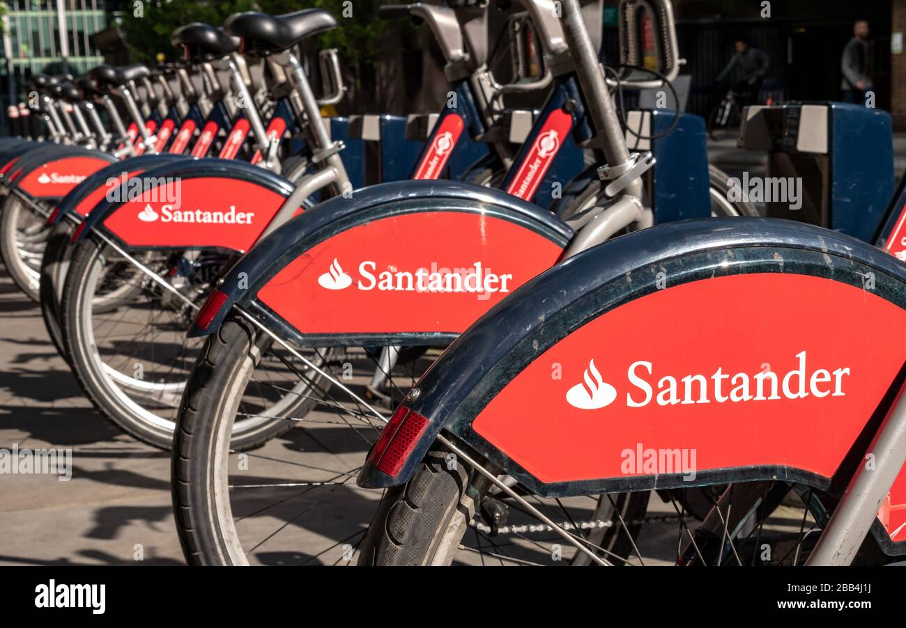 Santander Cycles docking station. A row of London hire bicycles with their prominent corporate sponsorship. Stock Photo