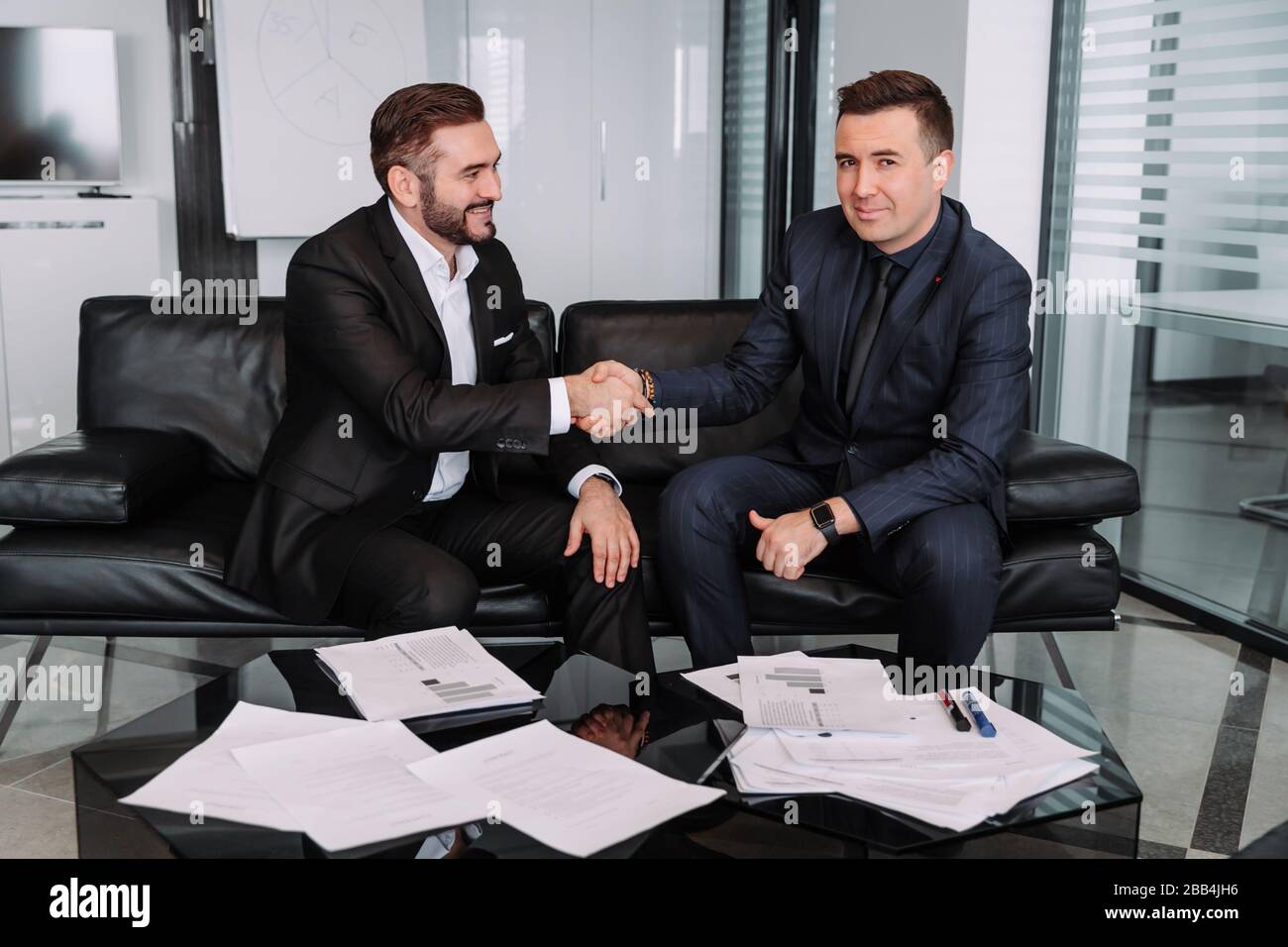 image of a strong handshake between two colleagues after signing a ...