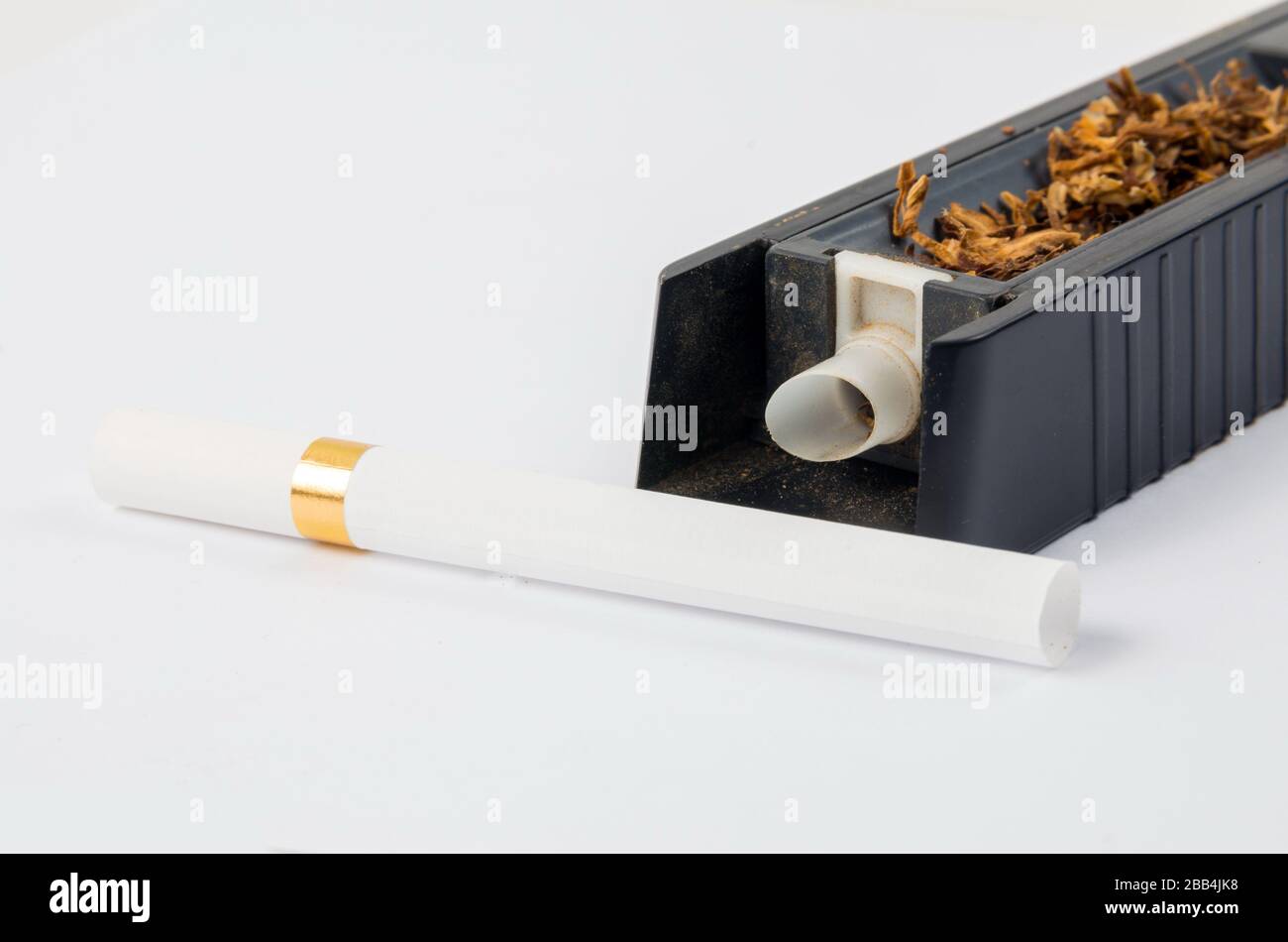 Tobacco cigarette making machine on the white Stock Photo Alamy