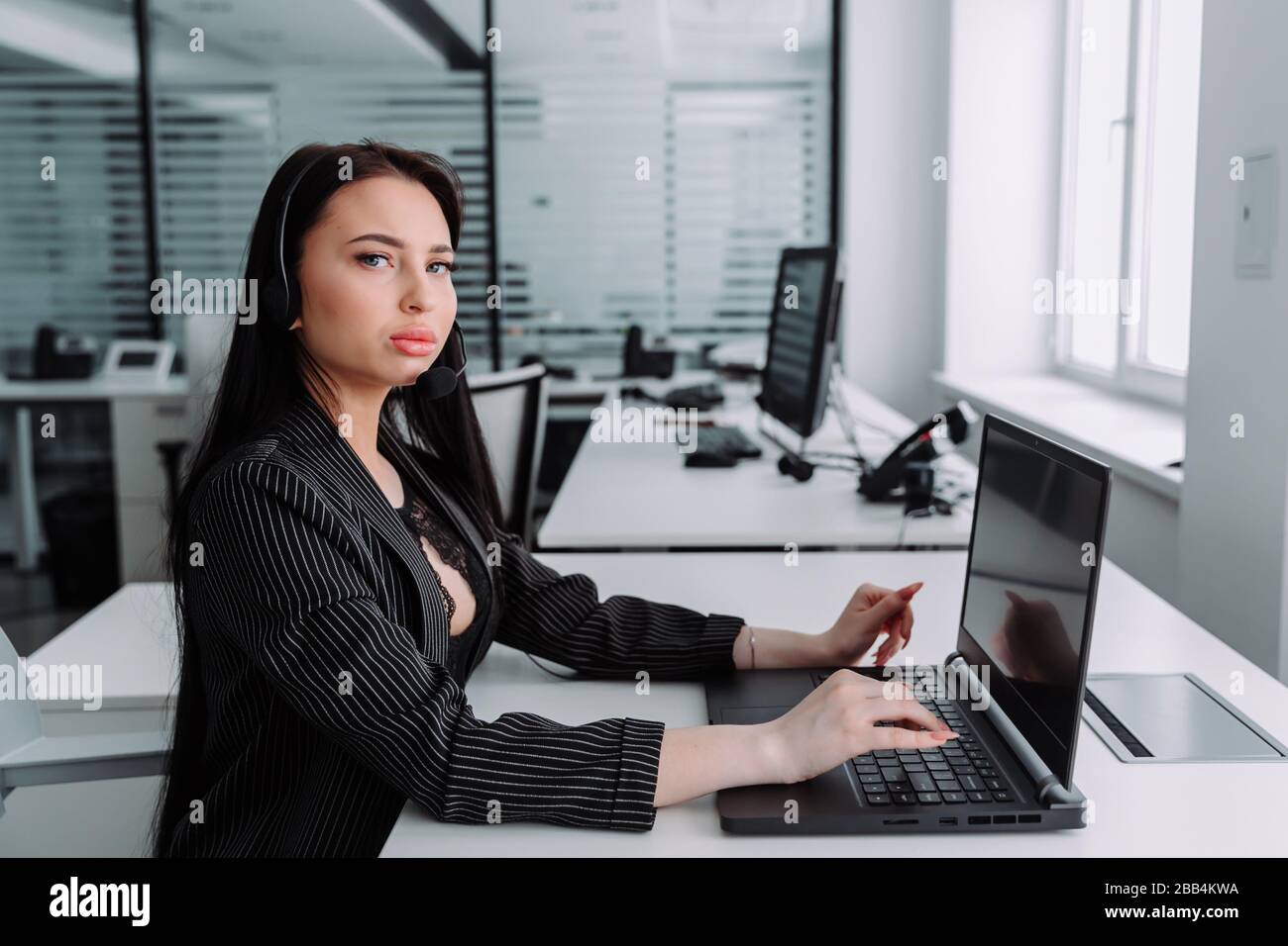 Call center. Focus on the beautiful woman in the headset Stock Photo