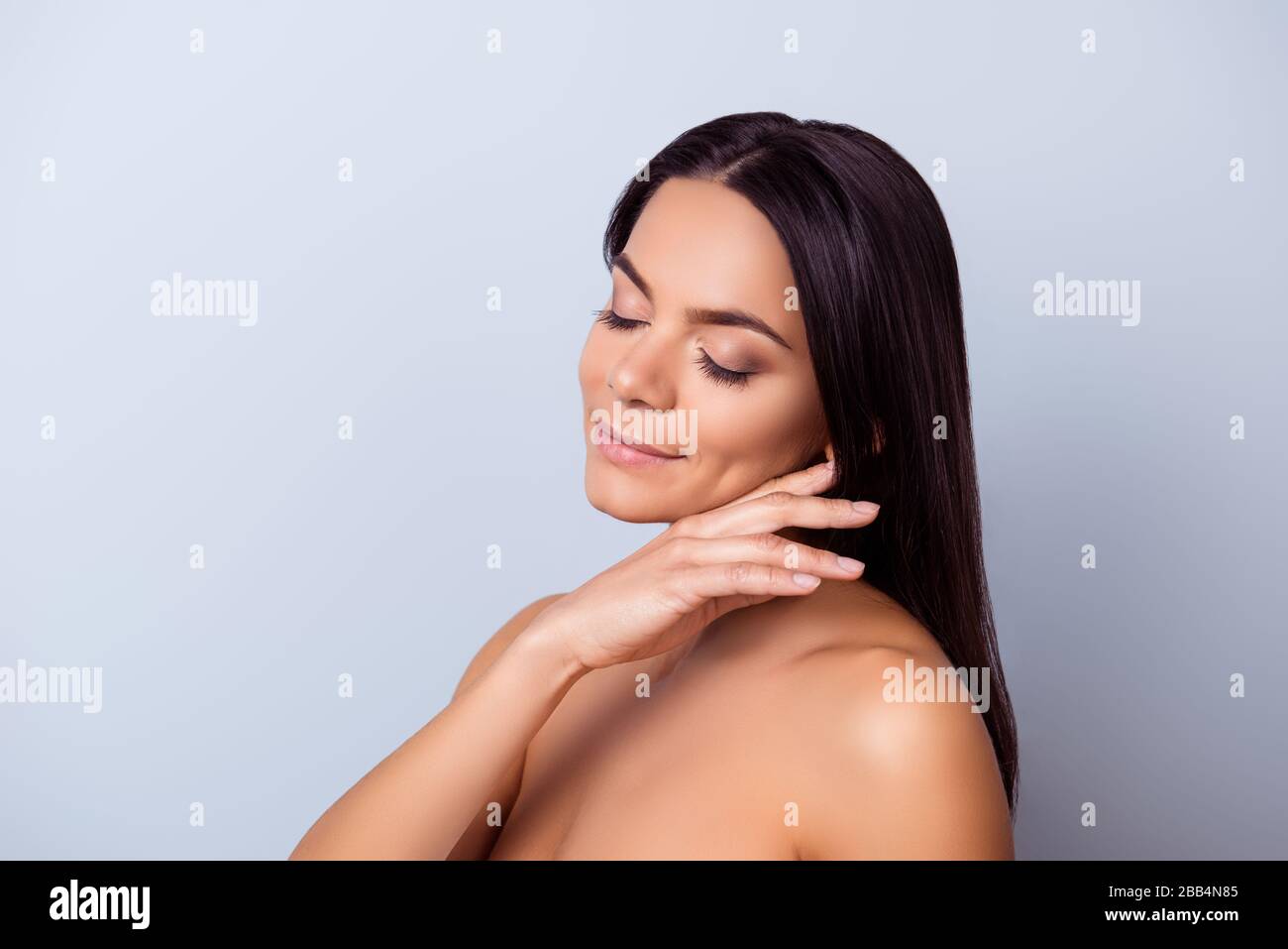 So cute and pure! Young pretty hispanic mulatto charming girl is touching  gently her shining healthy bronze skin Stock Photo - Alamy