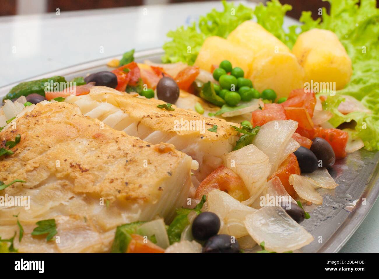 Traditional Portuguese Cod with potatoes, peas and vegetables Stock Photo Alamy