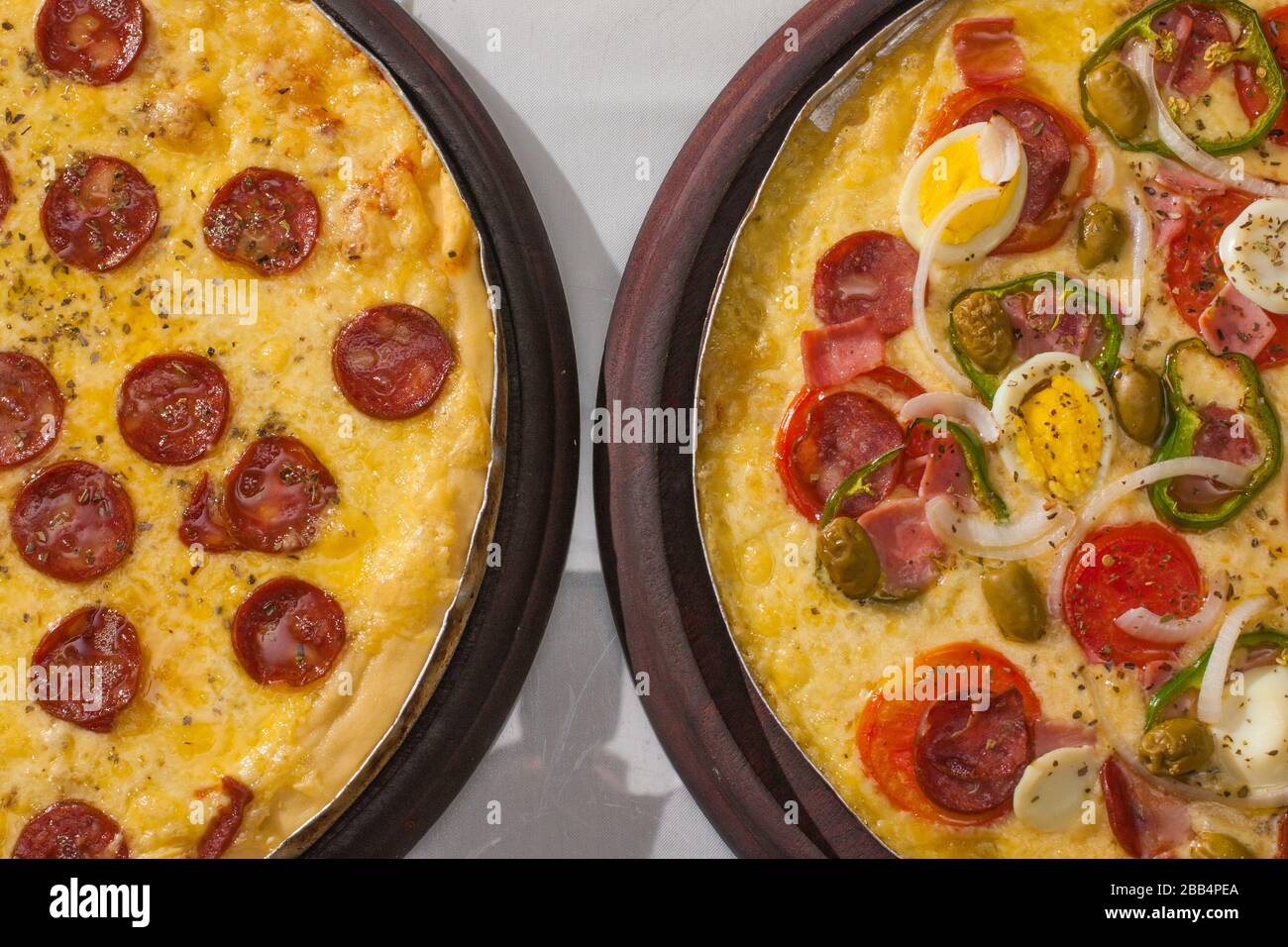 Traditional Calabresa and Portuguese pizza with fresh ingredients Stock Photo