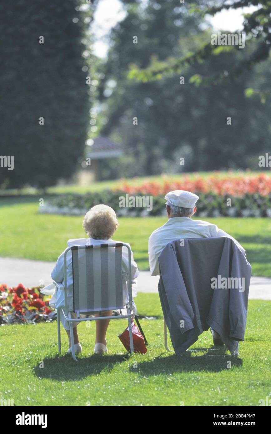 Two pensioners sitting in folding chairs at Southend Cliff gardens, Southend-on-Sea. Southend, Essex. England. UK Stock Photo