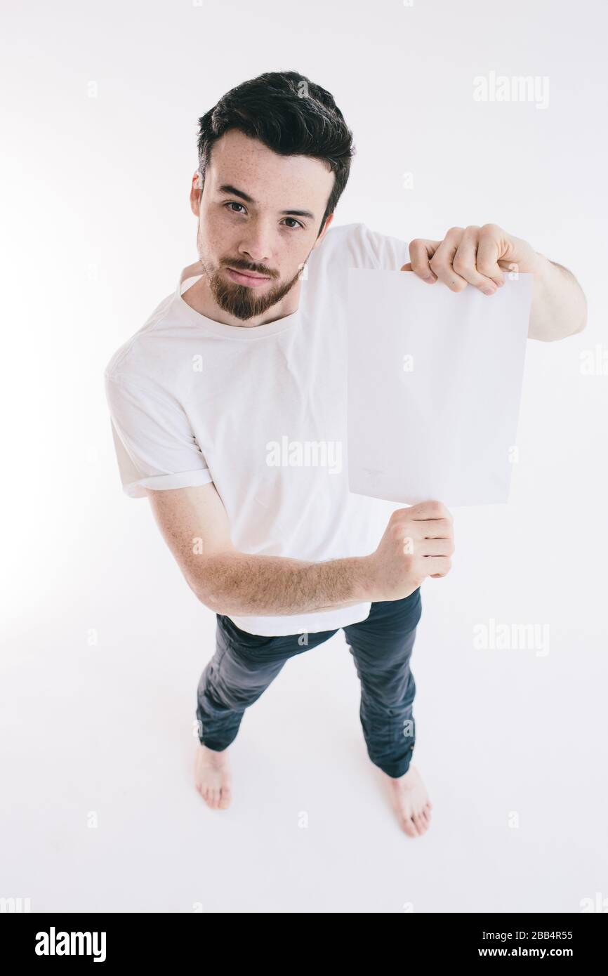 Bearded Man Holding A Blank White Sheet Of Paper Stock Photo Alamy