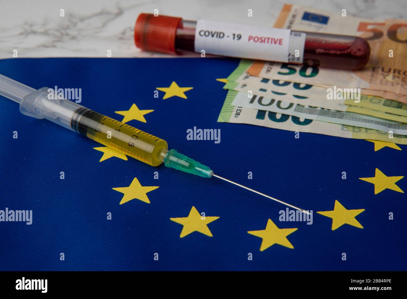 coronavirus vaccine with Euro banknotes on European Union flag Stock Photo