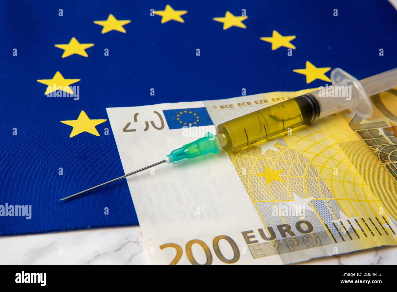 coronavirus vaccine with Euro banknotes on European Union flag Stock Photo