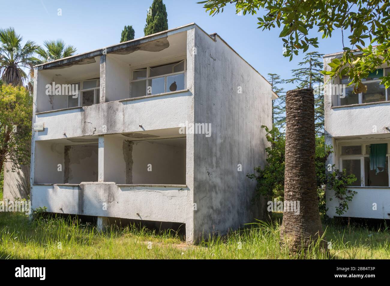 disused and overgrown holiday complex building Stock Photo - Alamy