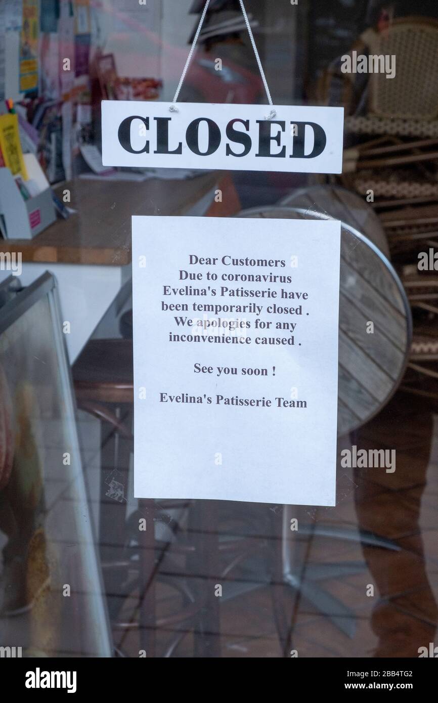 Coronavirus Covid-19 notices in a Patisserie shop window in Muswell Hill London, 29th March 2020 Stock Photo