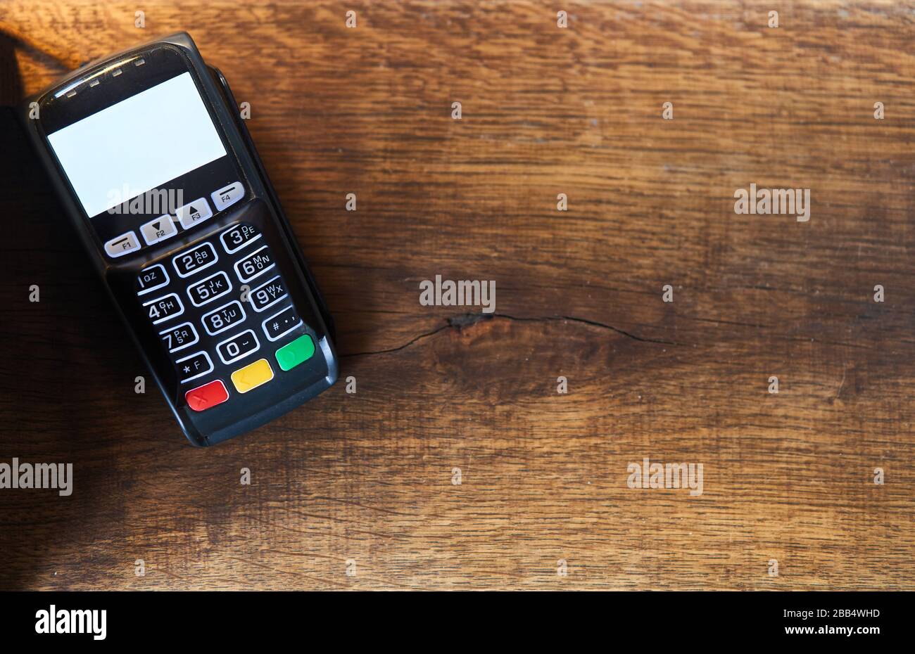 Bank pos terminal on a wooden background.  Stock Photo