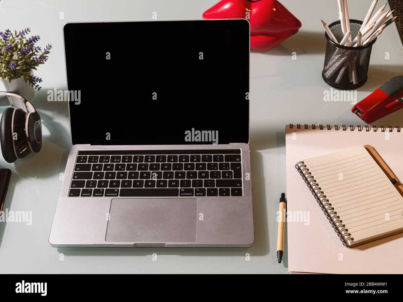 laptop on the glass table. Improvised office in the living room. Telework concept Stock Photo