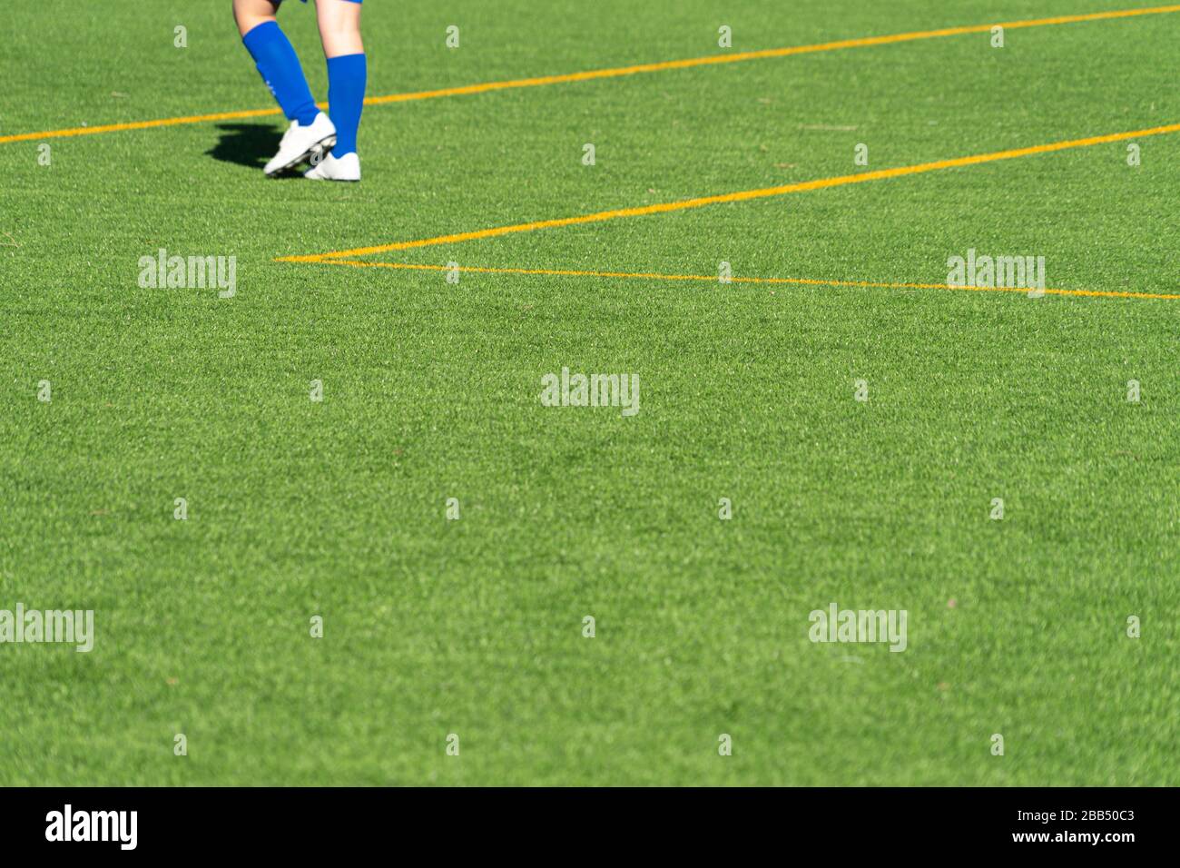Youth soccer player feet on empty green grass football practice ground Stock Photo Alamy