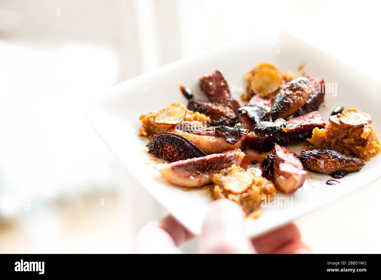Plate of fine dining well presented Duck and Plum dish. Stock Photo