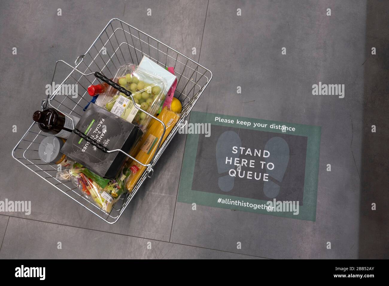 Streatham, UK. 30th Mar, 2020. Stand Here To Queue signs on the floor at a Marks & Spencer supermarket in Streatham in South London, England. ( Credit: Sam Mellish/Alamy Live News Stock Photo