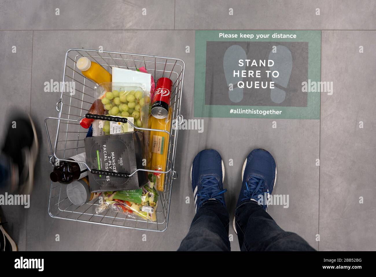 Streatham, UK. 30th Mar, 2020. Stand Here To Queue signs on the floor at a Marks & Spencer supermarket in Streatham in South London, England. ( Credit: Sam Mellish/Alamy Live News Stock Photo