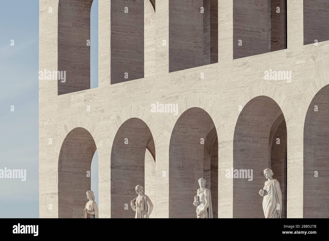 Detail of the facade with the marble arches and the statues at the ground floor. Palazzo della Civiltà Italiana, Rome, Italy. Architect: Giovanni Guer Stock Photo