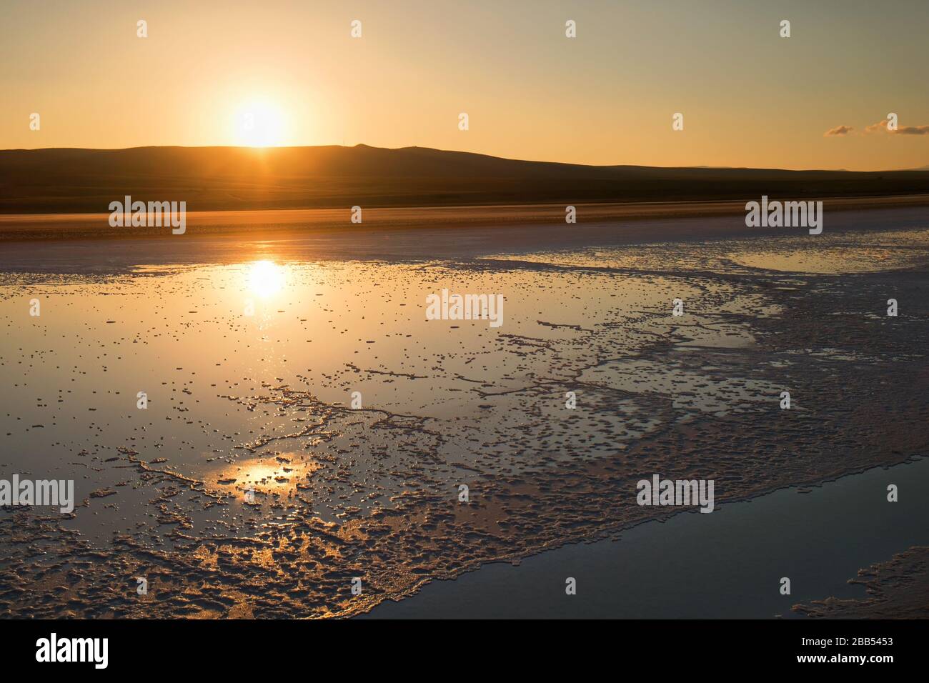 Abstract sunrise with reflections on water at The Salt Lake - Turkey Stock Photo