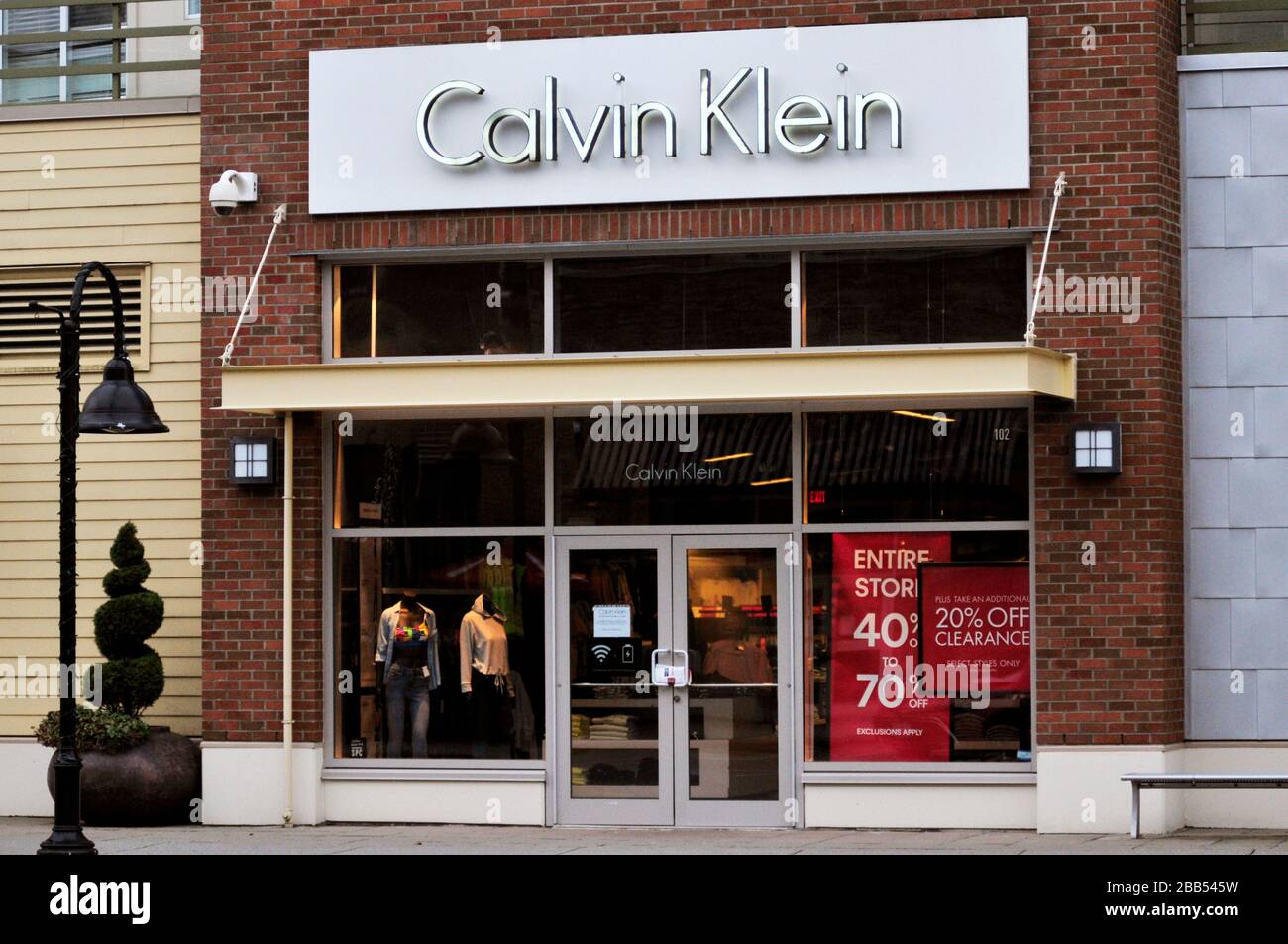Surrey, , Canada. 29th Mar, 2020. A sign is seen in the window of a  closed Calvin Klein retail store location, during the COVID-19 pandemic.  Photo by Adrian Brown/Sipa USA Credit: Sipa