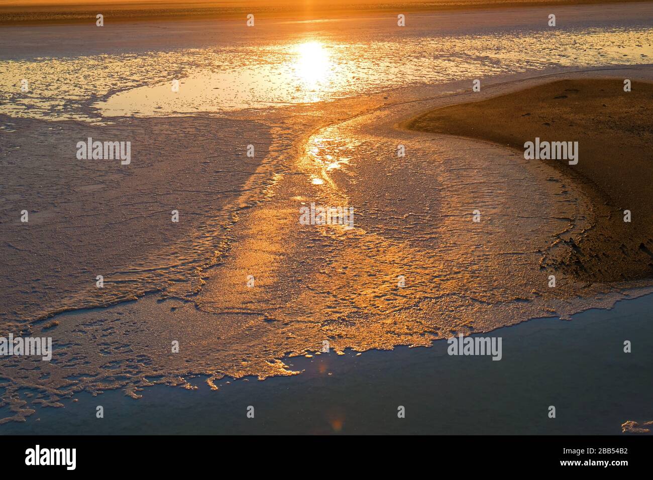 Abstract sunrise with reflections on water at The Salt Lake - Turkey Stock Photo
